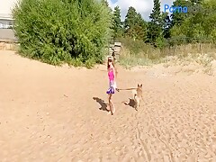 Beauty Sonya on the seashore with a dog